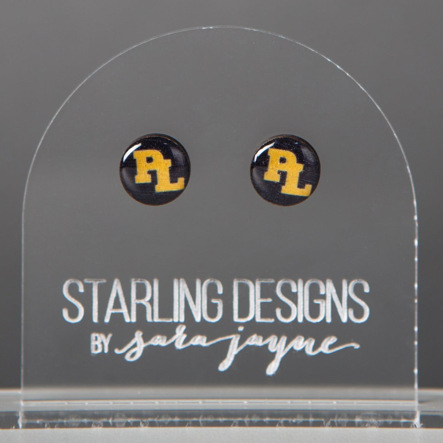 Prior Lake Yellow PL on Navy stud earrings