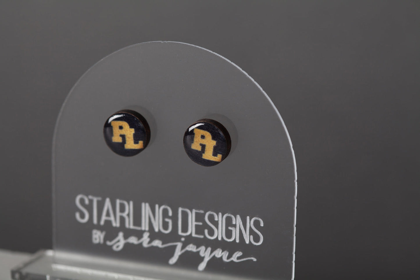 Prior Lake Yellow PL on Navy stud earrings